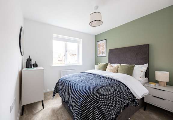 a bedroom with a bed and a dresser and a window