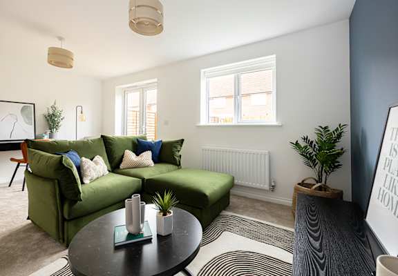 a living room with a green couch and a coffee table