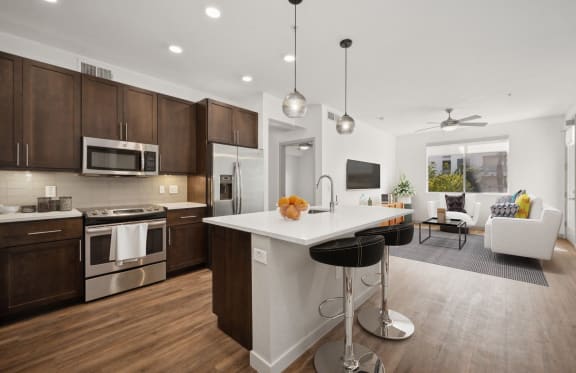 a kitchen and living room with a large white counter top