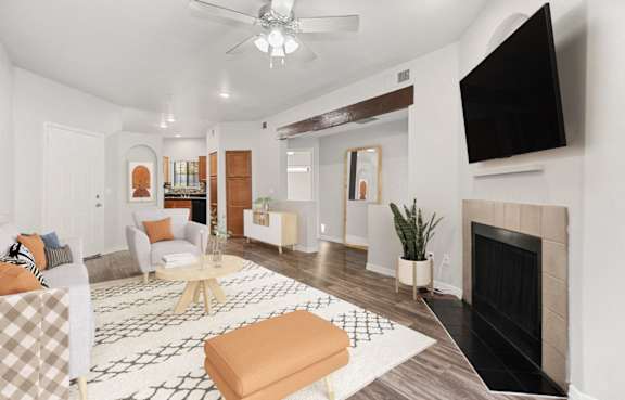 a living room with a fireplace and a tv