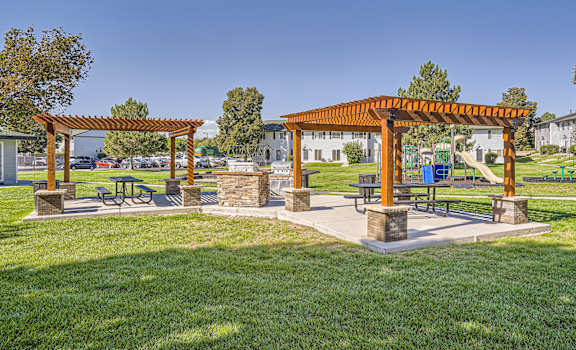 A park with a pavilion and picnic tables.
