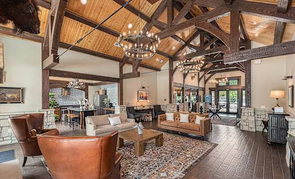 a living room filled with furniture and a large chandelier
