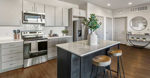 A kitchen with stainless steel appliances at Parkside at Littleton Village apartments in Littleton, Colorado.