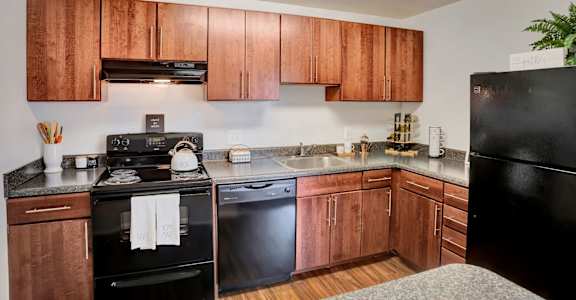 a kitchen with wooden cabinets and black appliances, Kenilworth at Charles Apartments, Towson, MD