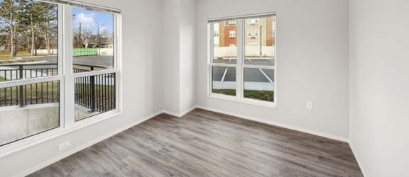 A room with a ceiling fan and sliding glass doors.