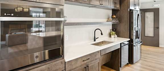 A modern kitchen with wooden cabinets and stainless steel appliances.