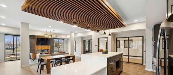 A modern kitchen with a wooden ceiling and a large island.