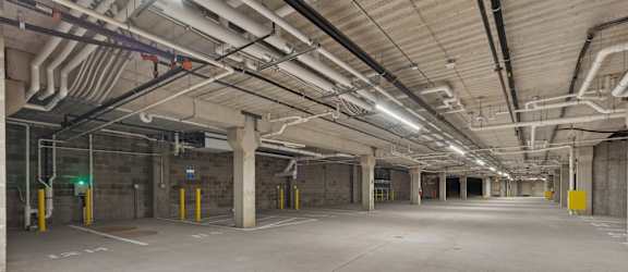 A large, empty parking garage with concrete floors and walls.