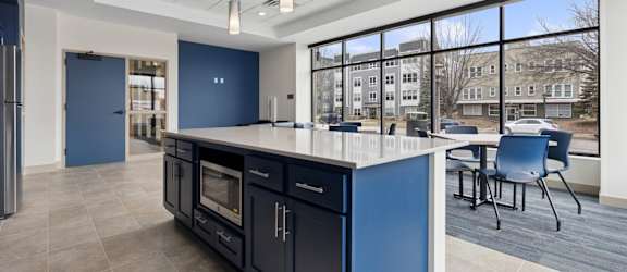 A kitchen with blue cabinets and a large island.