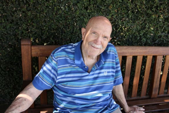 an older man sitting on a bench