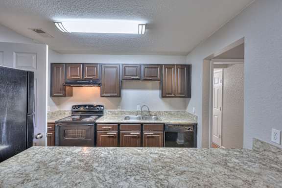 A kitchen with granite countertops and stainless steel appliances at Landmark at Lyncrest Reserve Apartments, Nashville, TN, 37209