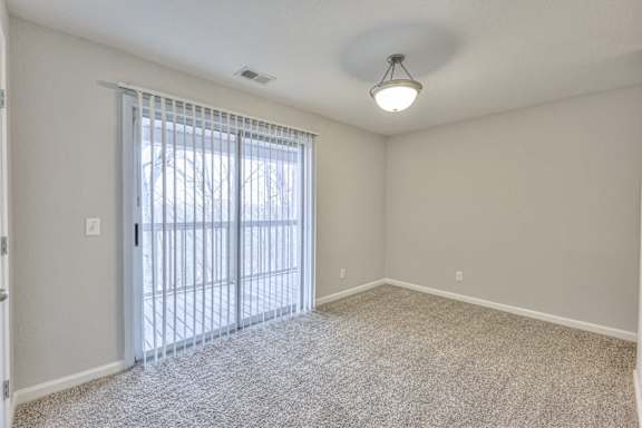 A room with a sliding glass door leading outside at Landmark at Lyncrest Reserve Apartments, Nashville, TN, 37209