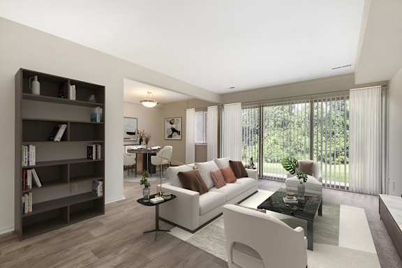a living room with a white couch and a table at Copper and Quarry Village, Pikesville, MD, 21209