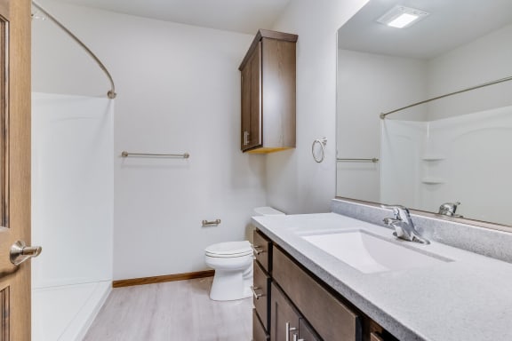 a bathroom with a toilet sink and shower