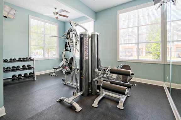 A gym with a variety of equipment including a leg press machine.