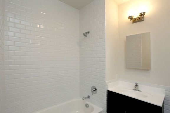 bathroom with white tiled shower