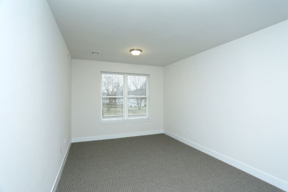bedroom with white walls and carpeted floors