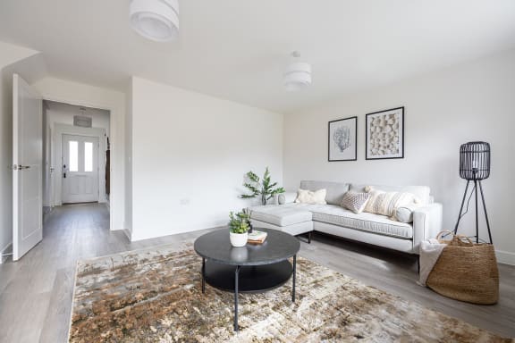 a living room with a couch and a glass table