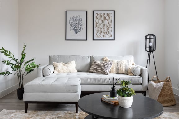 a living room with a couch and a glass table