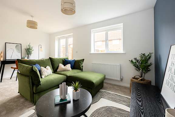 a living room with a couch and a glass table