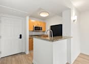 Thumbnail 34 of 67 - Kitchen with black fridge and cabinets at AVIA on Pike Street, Seattle, WA, 98101