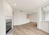 Thumbnail 38 of 67 - Room with shiny wooden floor and fireplace at AVIA on Pike Street, Seattle, Washington