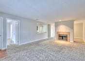 Thumbnail 8 of 28 - A spacious living room with a fireplace and a carpeted floor at Landmark at Lyncrest Reserve Apartments, Nashville, TN, 37209
