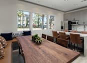 Thumbnail 29 of 62 - Clubroom kitchen and dining area at The Grove Apartments, California