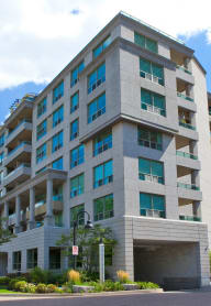 an apartment building with a blue sky in the background