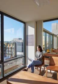 a woman sitting on a chair in a window