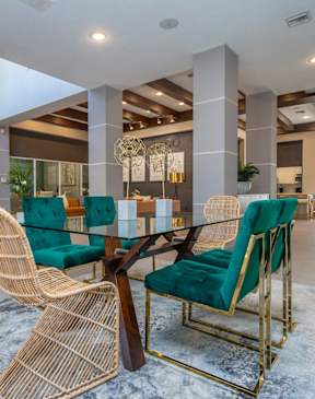 A modern dining room with a glass table and chairs.
