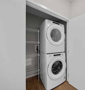 a washing machine and a dryer in a white closet