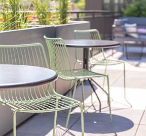 A green chair is placed near a table.