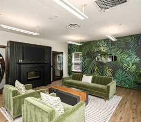A living room with a green couch and a fireplace.