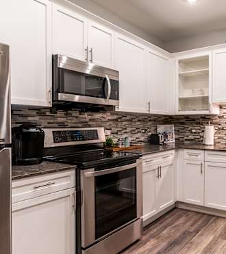a kitchen with stainless steel appliances and white cabinets