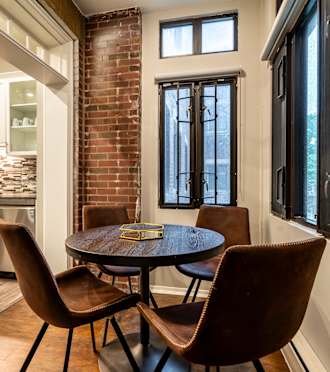 a dining room with a table and chairs next to a kitchen