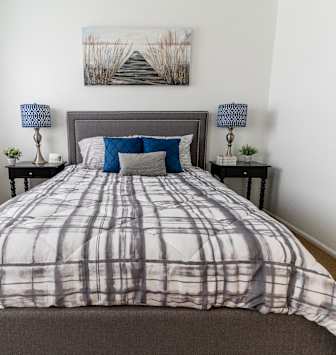 an overview of a bedroom with a bed and a window
