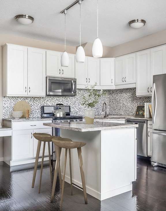 Kitchen with White Cabinets at 71 France, Edina