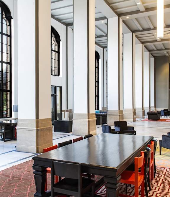 A large room with a long table and chairs.