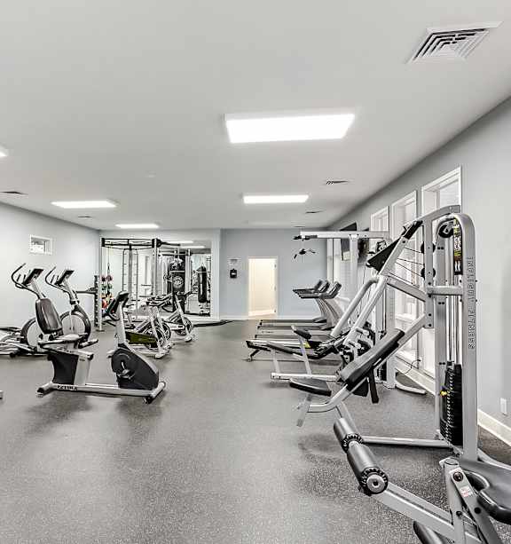 A spacious gym with a variety of equipment.