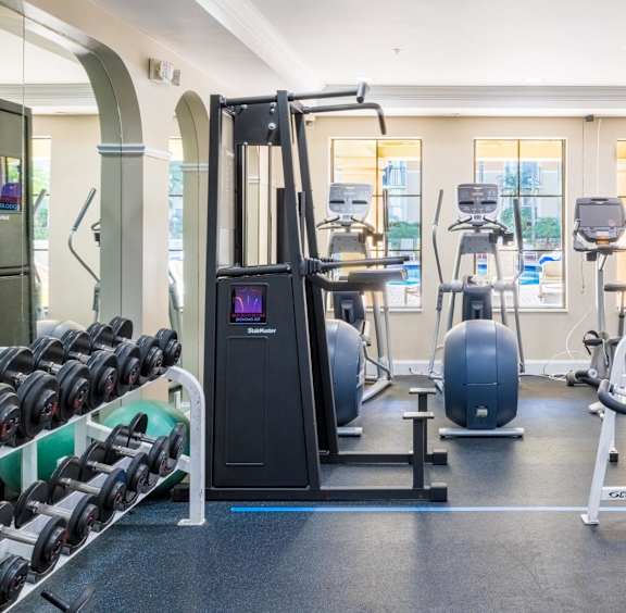 a gym with weights and cardio equipment in the wellness center