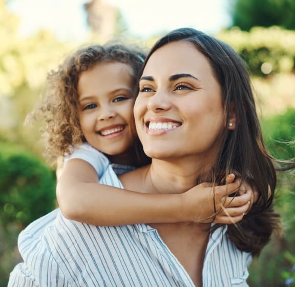 woman carrying child on back