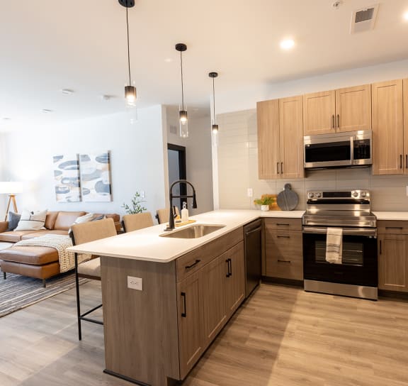 a kitchen with white countertops and wooden cabinets