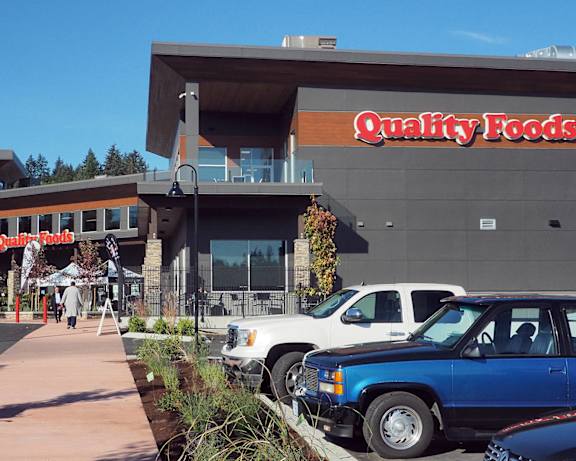 the front of qualitatively foods with cars parked outside