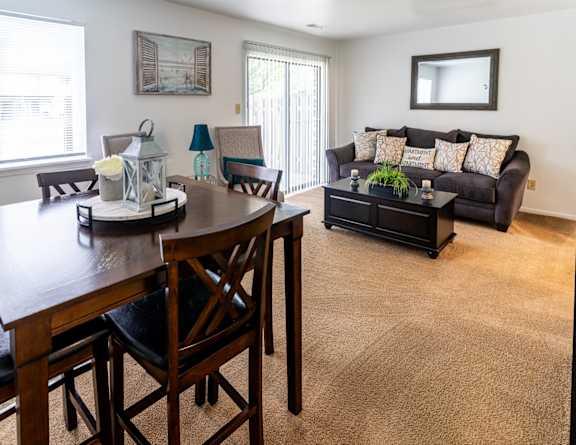 an open living room and dining room with a couch and a table