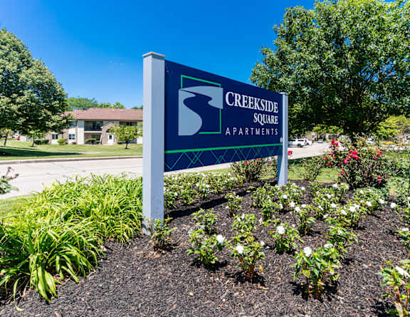 the sign at the entrance to bath farms with flowers
