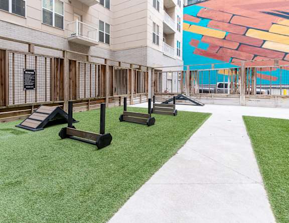 a group of exercise equipment in a courtyard at an apartment building