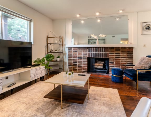 a living room with a fireplace and a television