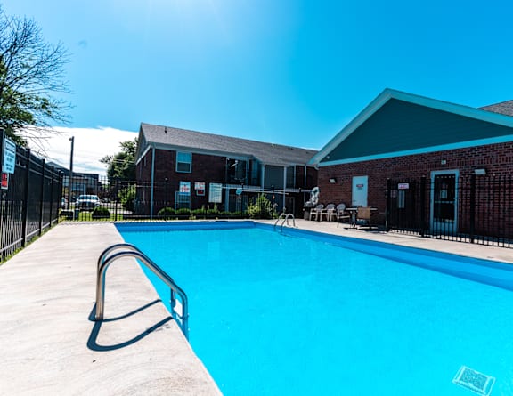 our resort style swimming pool is next to our building with lounge chairs