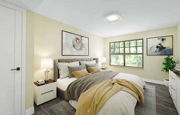 A bedroom with a bed, nightstands, and a window.